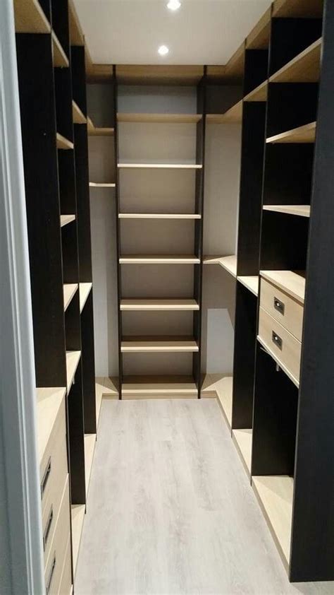An Empty Walk In Closet With Shelves And Drawers