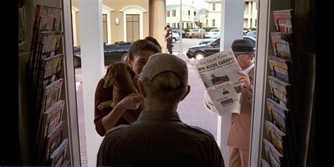 In The Truman Show The Person With The Hat Can Be Seen Reading The