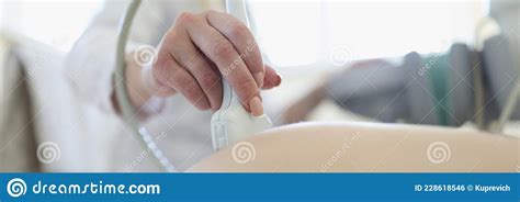 Doctor Conducting Ultrasound Examination Of Fetus Of Pregnant Woman In