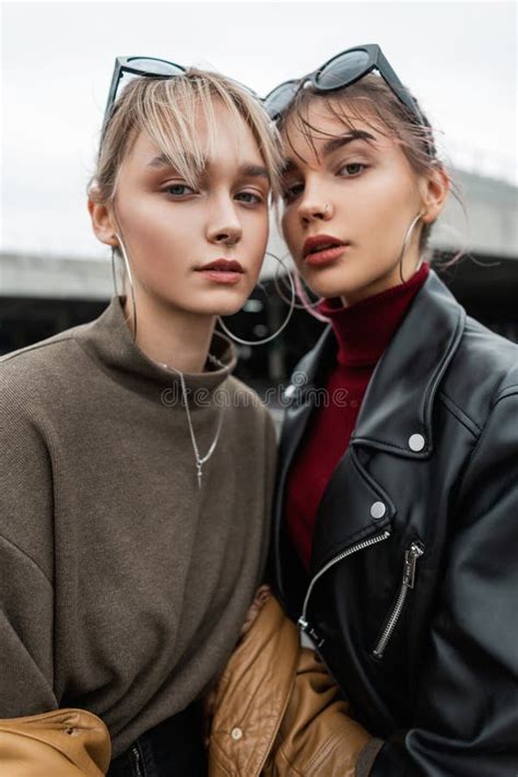 Fashionable Portrait Of Beautiful Young Women Sisters With Stylish Clothes In Black Leather