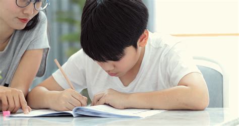 Asian Mom Is Helping Son To Do Homework Of Stock Footage SBV 321095465