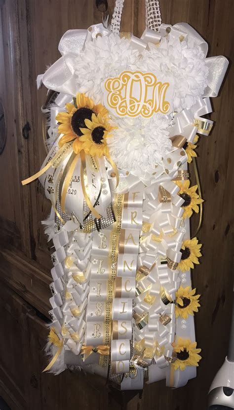 The Sunflowers And Ribbons Are Attached To The Door Hanger With