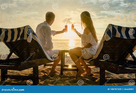 Couple Drinking Cocktails On Beach During Vacation Or Honeymoon In