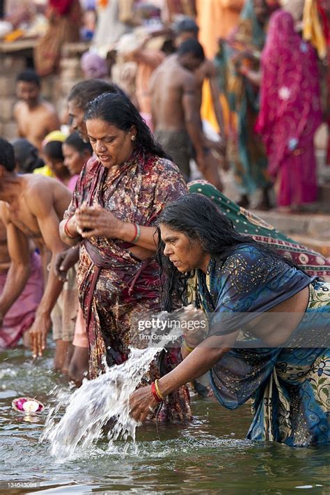 Indian Hindu Pilgrim Bathing And Praying In The Ganges River At