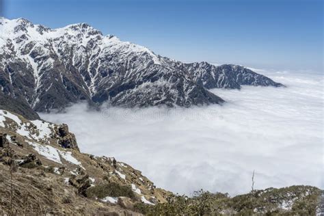 Snowy Mountains Risen Above Clouds At Himalayas During Sunny Day Stock