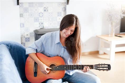 Young Woman Playing Guitar At Home Happy Girl Enjoying Music Female