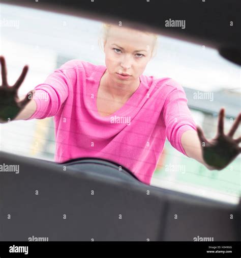 Woman Pushing A Car Stock Photo Alamy