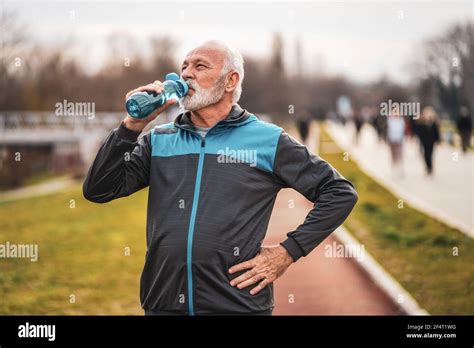 Active Senior Man Is Drinking Water After Exercising Healthy Lifestyle