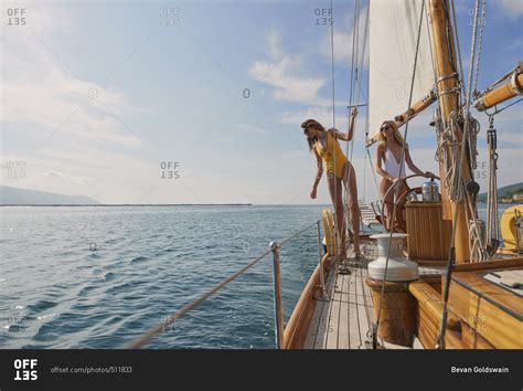 Beautiful Fashion Sexy Women Steering Luxury Sailboat In Ocean On