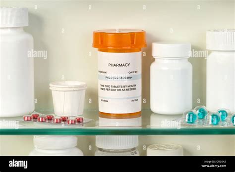 Prescription Bottle On Medicine Cabinet Glass Shelf With Medications