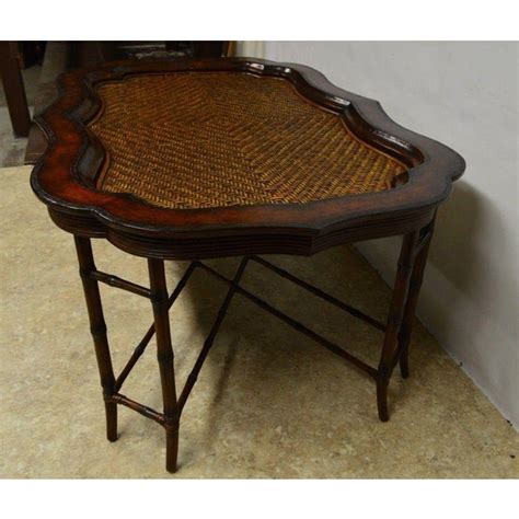 Organic yet sophisticated, this circular tray is crafted from paulownia wood and leather for a look that catches the eye without overwhelming. Maitland-Smith Rattan & Leather Bamboo Coffee Table | Chairish