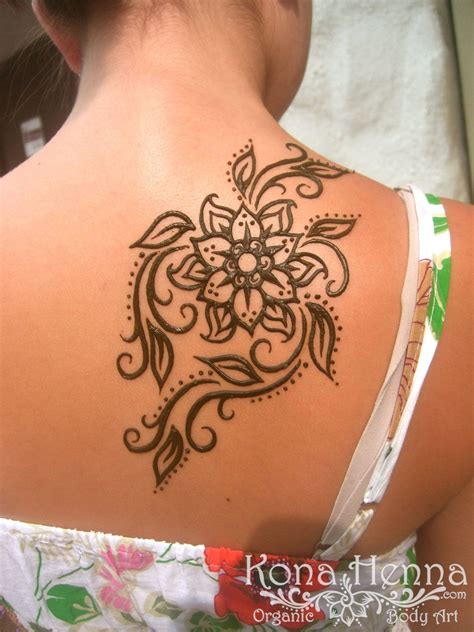 The Back Of A Womans Shoulder With A Henna Tattoo Design On It