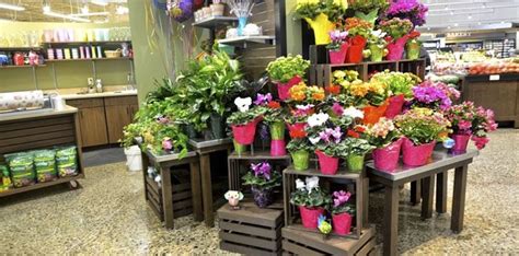 Use a large gathering of a singe type of flower for a big impact. Nesting table displays in the floral department of a ...