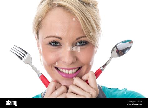 Model Released Happy Young Woman Holding Knife And Fork Stock Photo