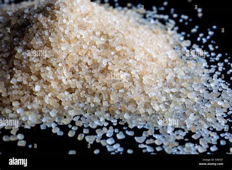 Brown Sugar Grains Scattered On Black Background Stock Photo Alamy