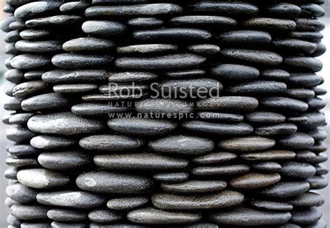 Repeating Pattern Of Stacked River Stones Or Rocks In Cylinder Shaped