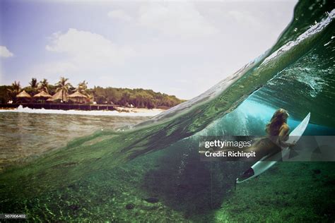 Over Under Duck Dive Photo Of A Surfer Girl High Res Stock Photo