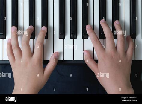 The First Basics In Music Fingers Of A Child On The Piano Keyboard