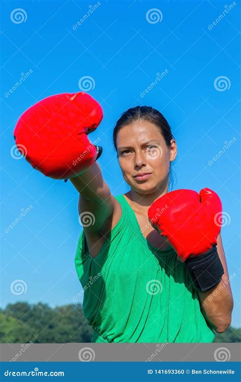 Young Woman Punches With Red Boxing Gloves Outside Stock Photo Image