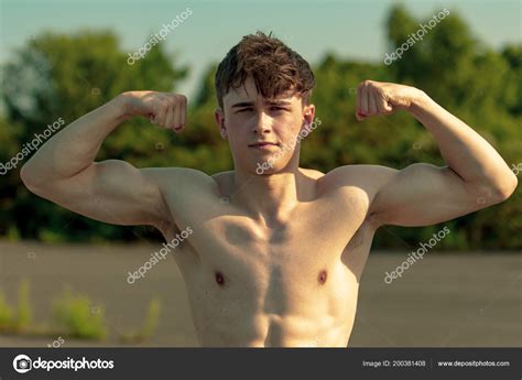 Young Adult Male Flexing His Muscles Shirtless Warm Summer