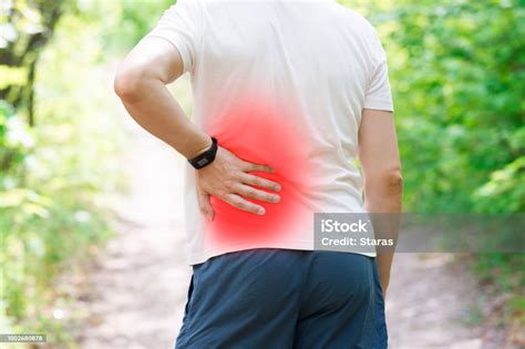 Man With Back Pain Kidney Inflammation Trauma During Workout Stock