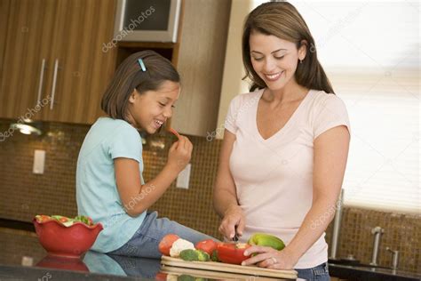 Mother And Daughter Preparing Mealmealtime Together Stock Photo By
