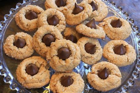 I used candy cane hershey kisses (a peppermint kiss with a tiny bit of crunch to it) and i swear i think i might leave my husband for these cookies. 25 Days of Christmas Cookies - Peanut Butter Blossoms ...
