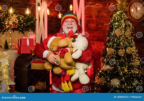 Cheerful Celebration Santa Claus Mature Man With White Beard Kind Grandpa With Soft Toys