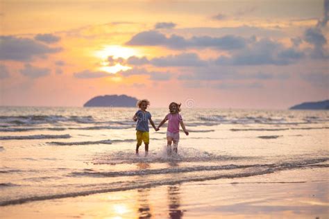 Child Playing On Ocean Beach Kid At Sunset Sea Stock Image Image Of