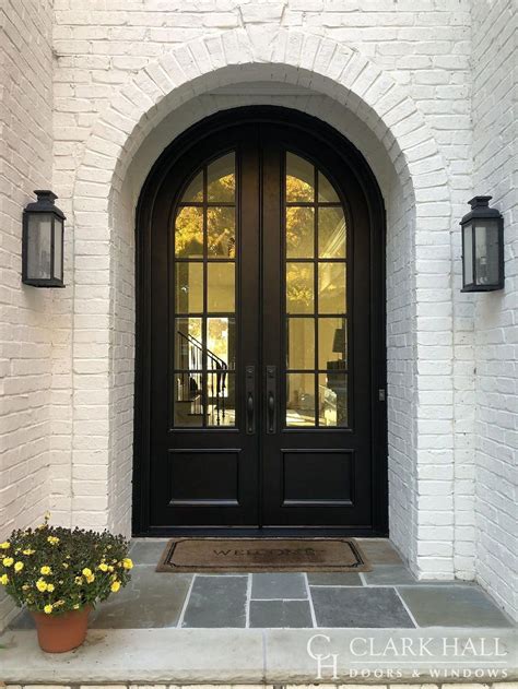 The Front Entrance To A Home With Two Large Doors