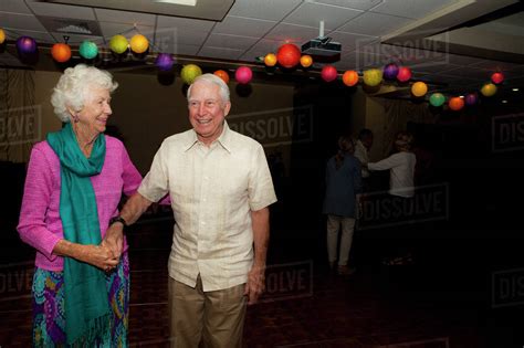 Older Caucasian Couple Dancing At Party In Retirement Home Stock