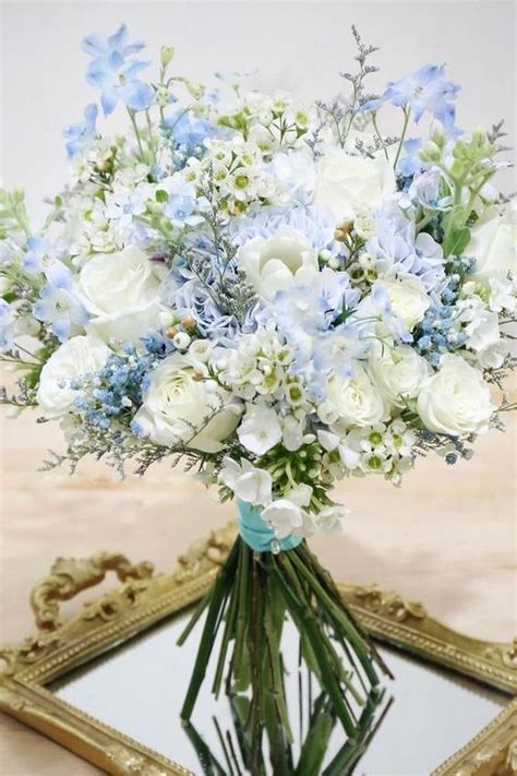 Perfect for the bride or bridesmaid. White roses and blue hydrangeas come together to create a ...
