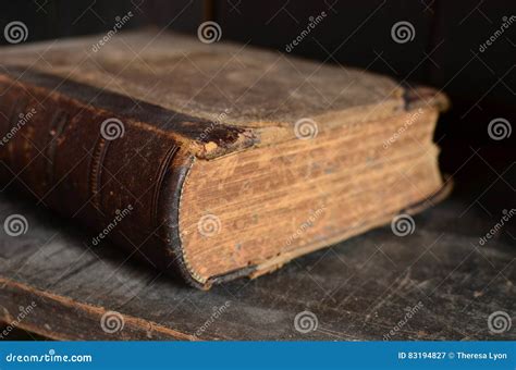 Old Leather Bound Book Laying On A Dusty Wooden Bookshelf Stock Image