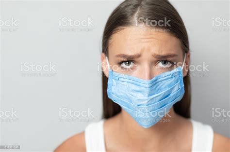 Unhappy Girl Wearing Mask During Pandemic Posing Over White Background