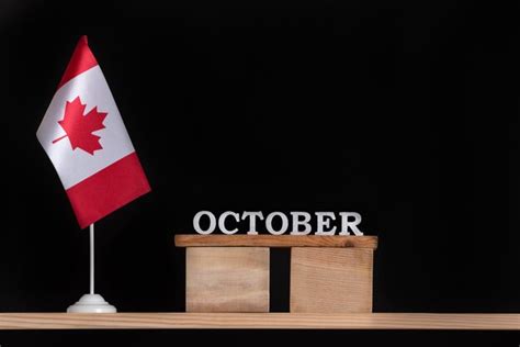 Premium Photo Wooden Calendar Of October With Canadian Flag On Black