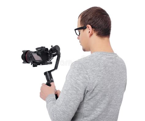 Back View Of Professional Videographer Using Dslr Camera On Gimbal