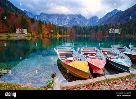 Alpine Lake And Colorful Boats Near Slovenian Italy Border Lake Fusine