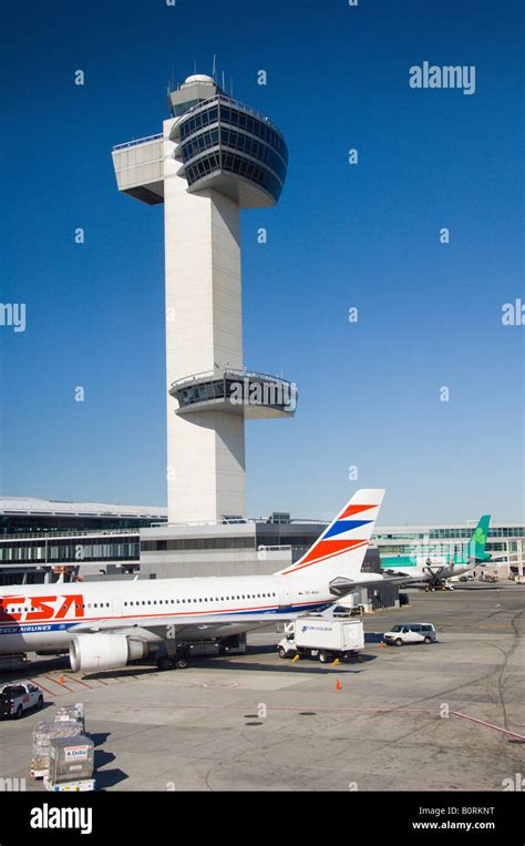 The Jfk International Airport Air Traffic Control Tower With Airplanes