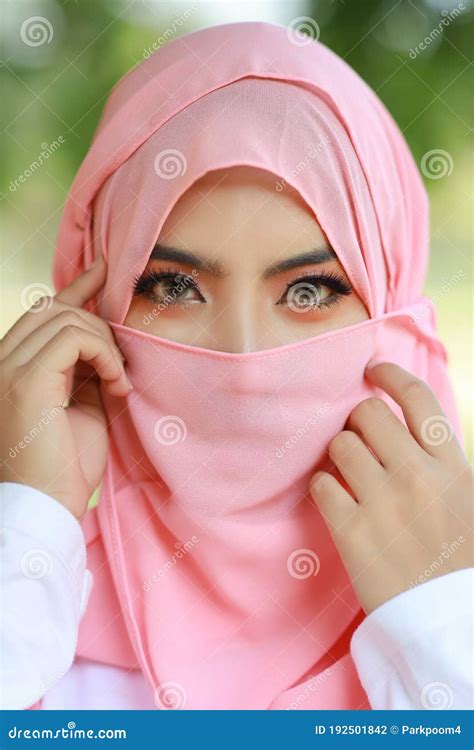 Pretty Young Asian Arabian Woman Wearing Pink Hijab Confident In Green Nature Outdoor Portrait