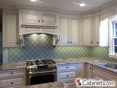 White cabinets black granite dark hardwood stainless steel. Bright white cabinets paired with aqua backsplash and ...