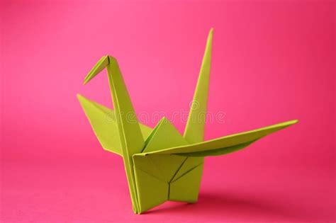 Origami Art Handmade Paper Crane On Pink Background Closeup Stock