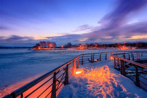 View Of A Frozen Lake During Sunrise In Winter Season Stock Photo