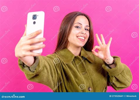 female making a peace sign with her hands while taking a selfie stock image image of vibrant