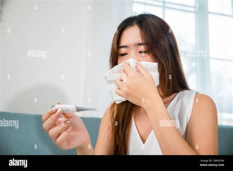 Sick Asian Young Woman Sit Under Blanket On Sofa She Sneeze With