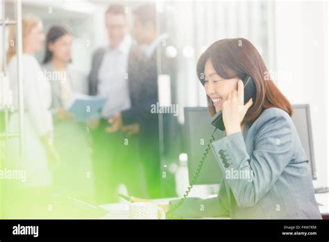 Smiling Businesswoman Talking On Telephone In Office Stock Photo Alamy