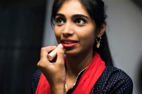 Free Photo Indian Woman Putting On A Lipstick