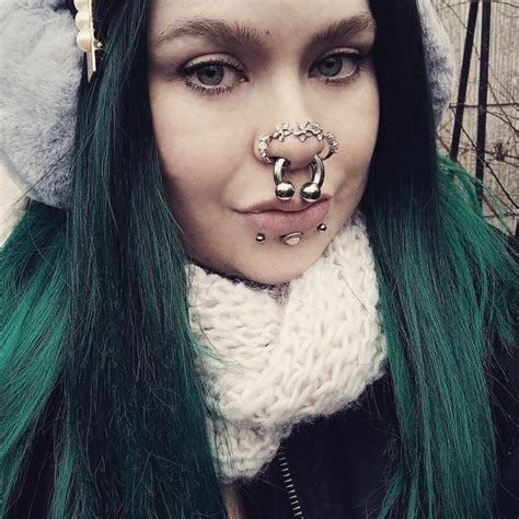 A Woman With Green Hair And Piercings On Her Nose