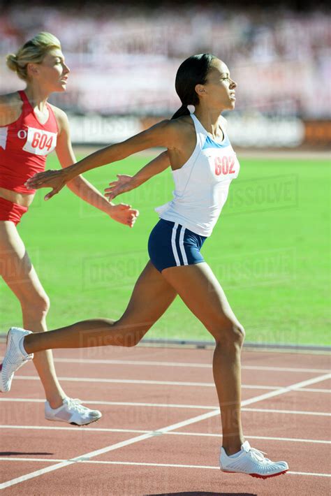 Female Runner Crossing Finish Line In Race Stock Photo Dissolve