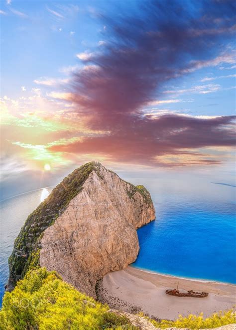 Navagio Beach With Shipwreck Against Colorful Sunset On Zakynthos