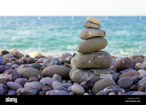 Stack Of Pebbles On Beach Against Sea Closeup Stock Photo Alamy